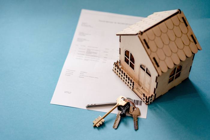 House model and keys on a contract